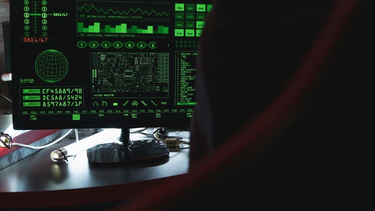 View of a computer monitor displaying green digital security code in an indoor setting.