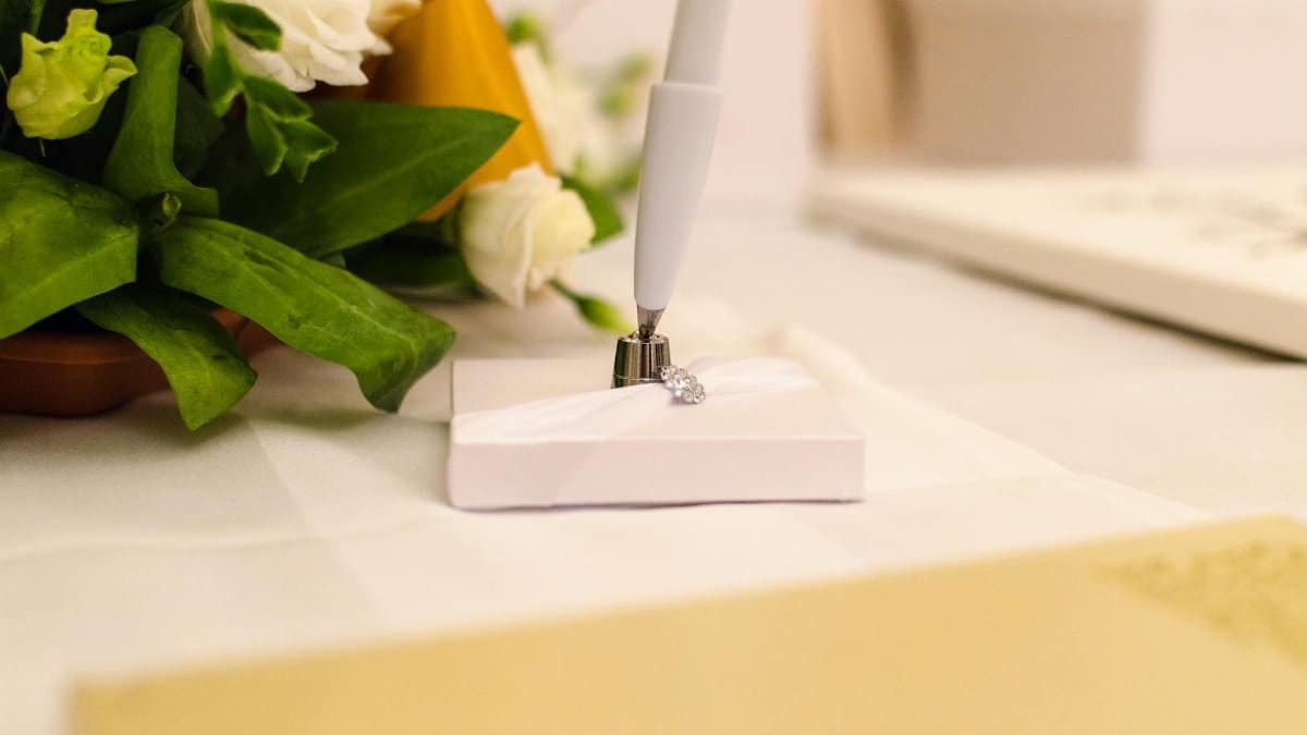 A beautifully decorated wedding signing table with flowers and a pen, capturing elegance and romance.