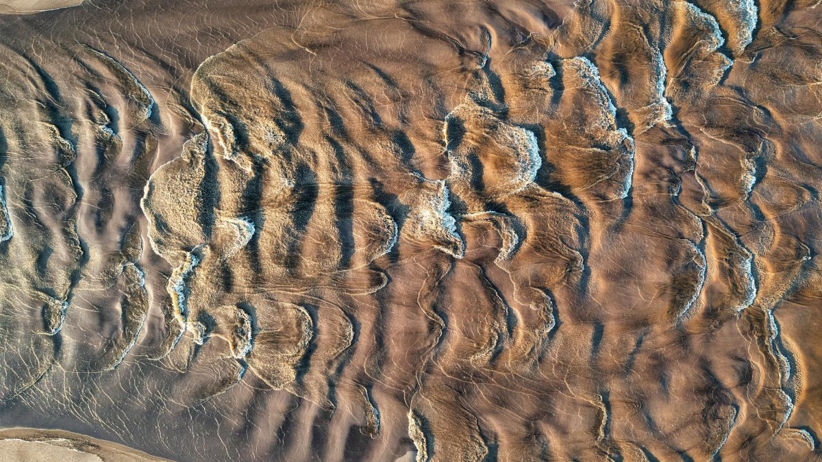 Captivating aerial view of intricate wavy sand patterns at Reads Landing, Minnesota.