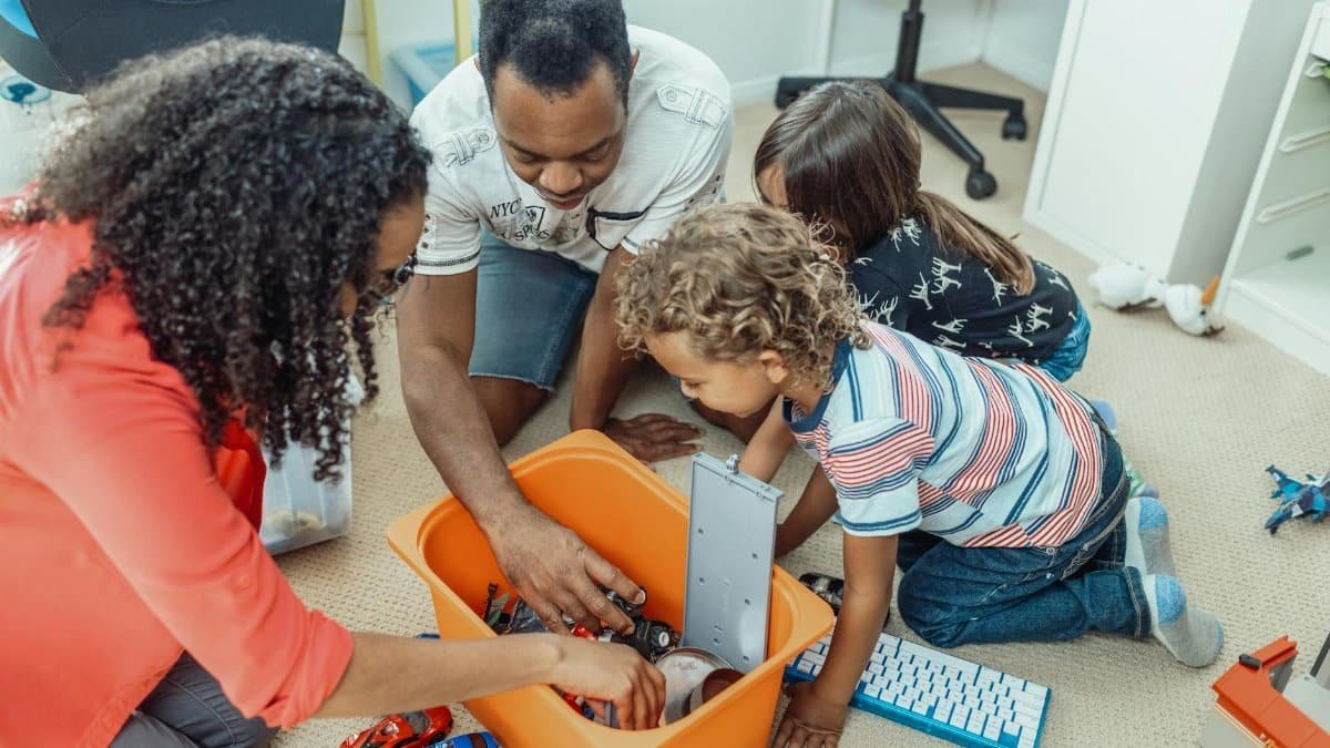 A multicultural family enjoying playtime together with toys indoors, fostering love and joy.