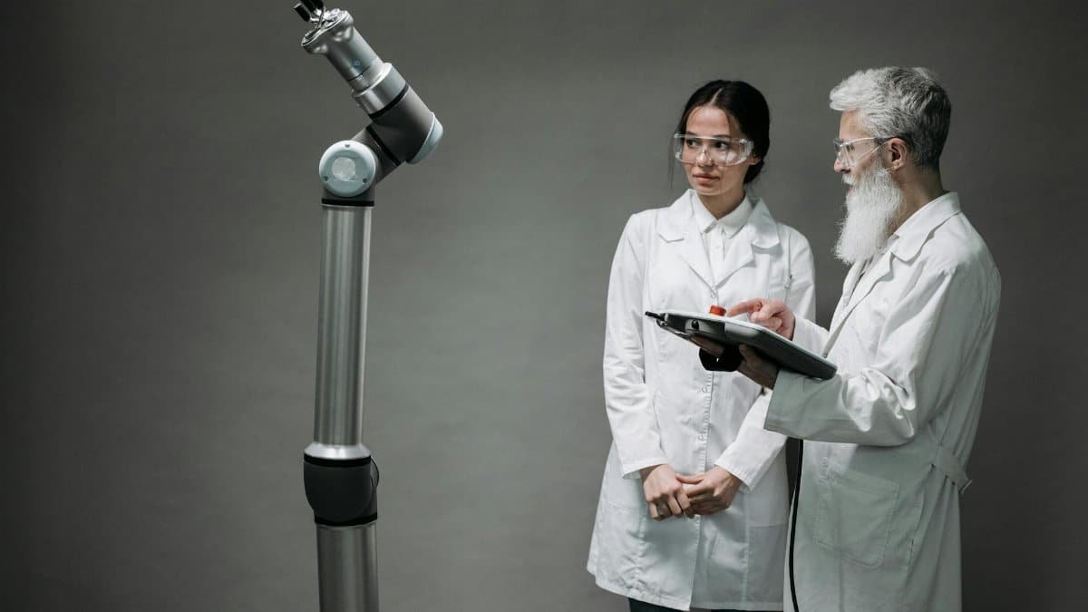 Researchers working with advanced robotics technology in a laboratory setting.