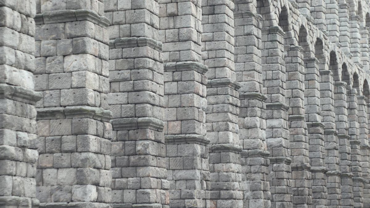 Detailed view of the Roman aqueduct's stone arches in Segovia, Spain.