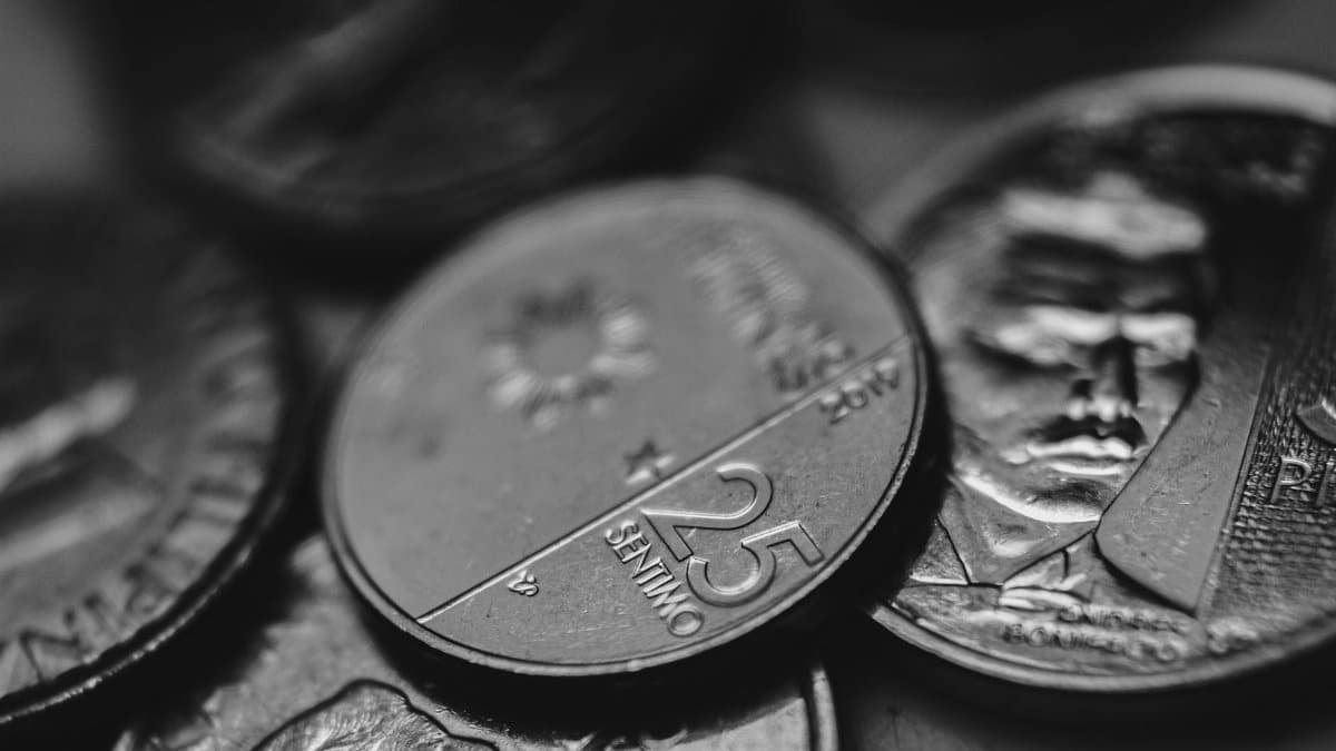 Detailed view of assorted coins highlighting different denominations in monochrome.