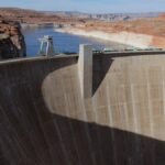 A breathtaking aerial view of Glen Canyon Dam with the Colorado River flowing beneath in Arizona.