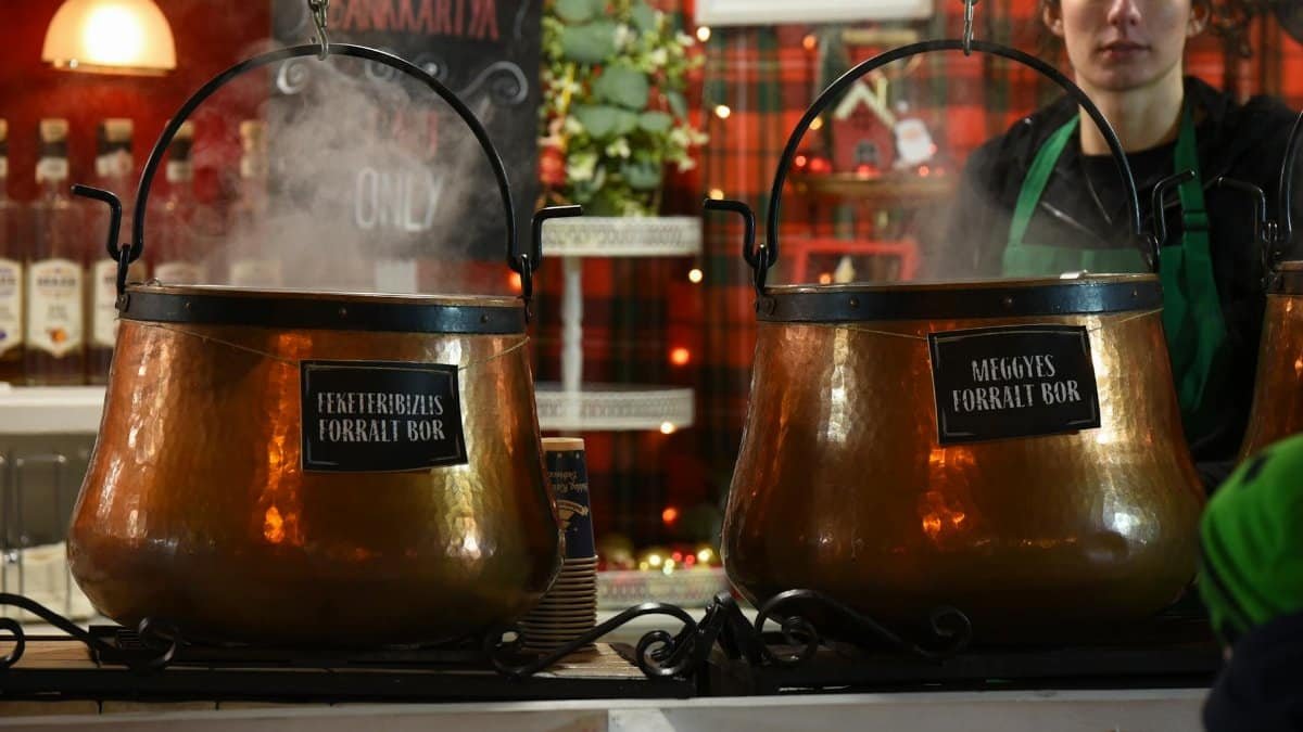 Steam rises from copper pots of mulled wine at a market stall in Debrecen, Hungary.