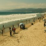 A vibrant scene at Santa Monica Beach with people enjoying a sunny day in Los Angeles.