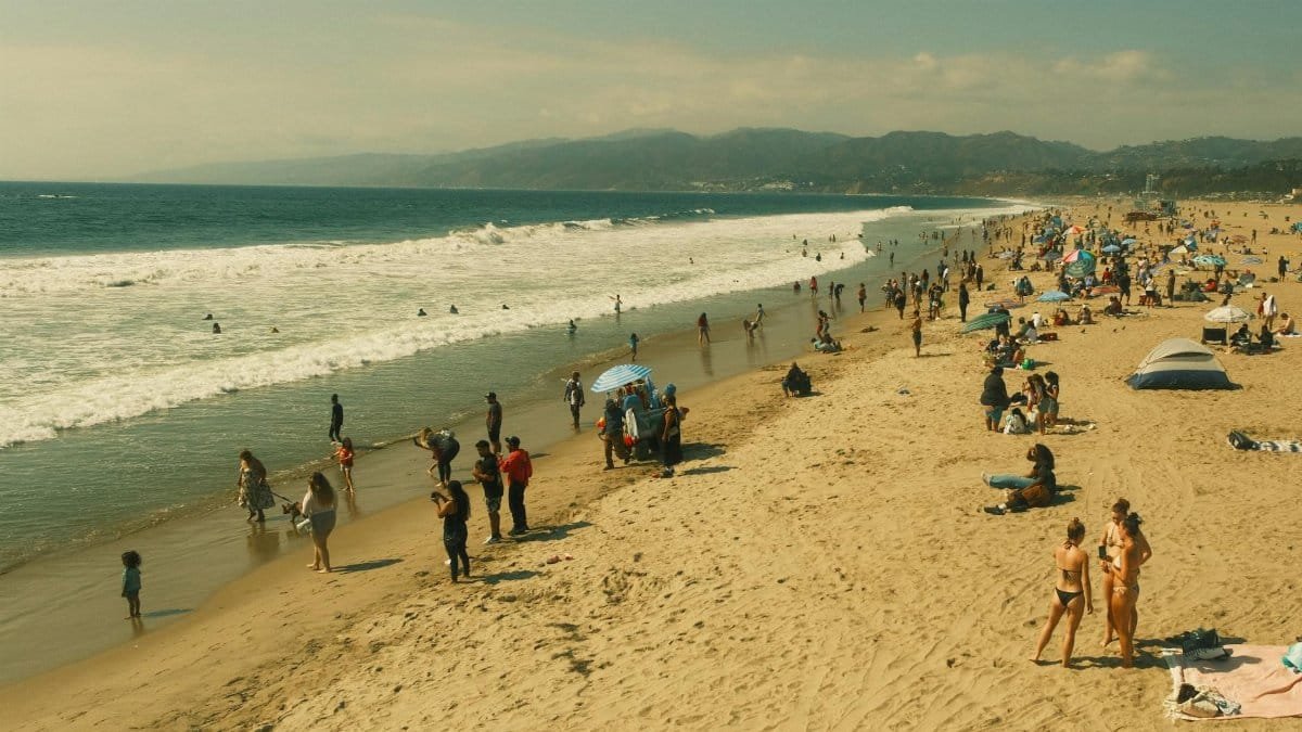 A vibrant scene at Santa Monica Beach with people enjoying a sunny day in Los Angeles.