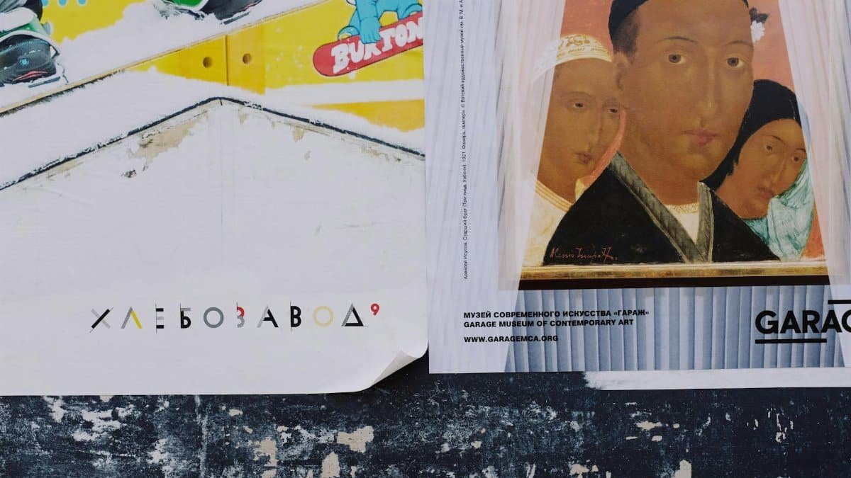 Old grunge textured background with colorful advertising posters in Russian language