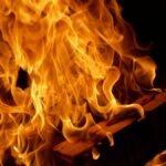 Dramatic close-up photo of bright flames against a dark background.