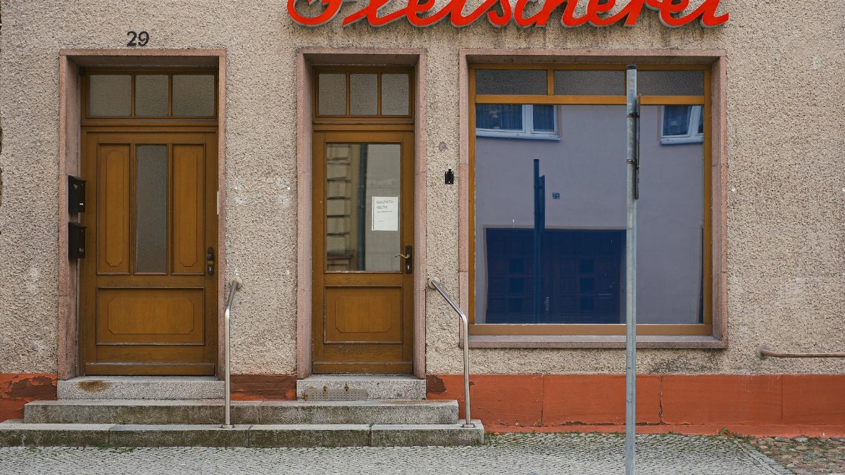 A quaint butcher shopfront with classic wooden doors in Luckau, Germany.