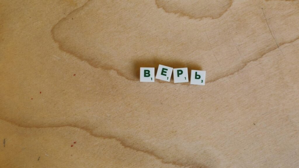 Scrabble tiles with Cyrillic letters spelling 'верь' displayed on a wooden surface.