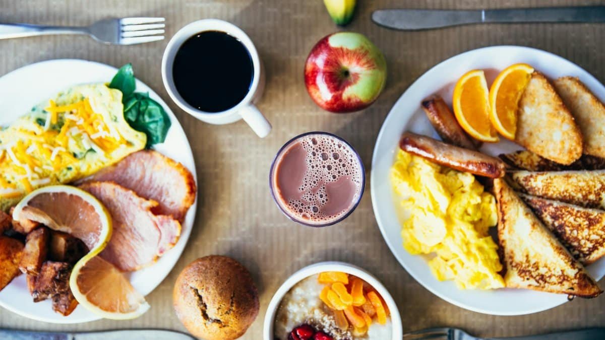 Vibrant breakfast with eggs, fruits, toast, and coffee for a wholesome start.