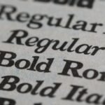 Detailed view of different font styles printed on paper, showcasing typography.