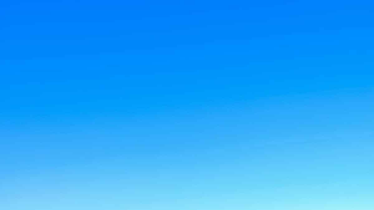 A serene view of a vibrant clear blue sky with a subtle gradient, perfect for backgrounds.
