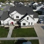 Aerial view of a modern suburban home in Spanish Fork, Utah, showcasing a neat neighborhood layout.