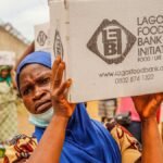 Community members engage in food distribution at Lagos Food Bank initiative event.