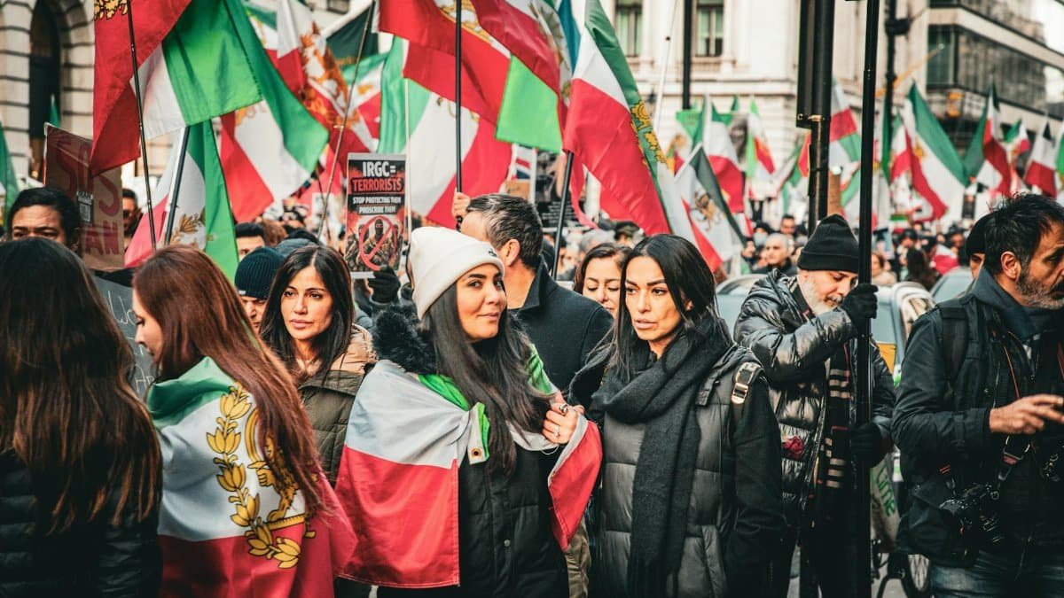 A vibrant street protest in London advocating for Iranian political change.