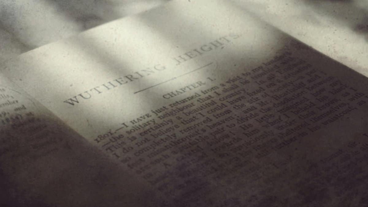 An open book with visible text in soft, nostalgic lighting creates a vintage feel.
