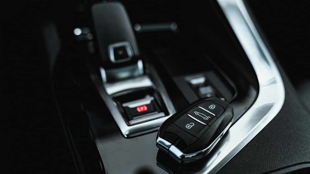 Close-up of modern car interior featuring a sleek car key and shifter, showcasing luxury design.