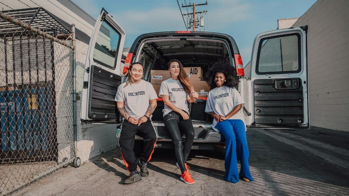 Group of volunteers with aid supplies in a van, ready to distribute to communities in need.