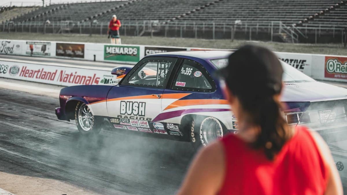 A thrilling drag race event at Heartland Nationals in Topeka, showcasing modified race cars and dynamic competition.