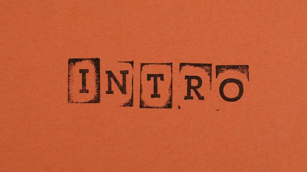 Close-up of the word INTRO stamped in black on an orange background, conveying a bold entrance.