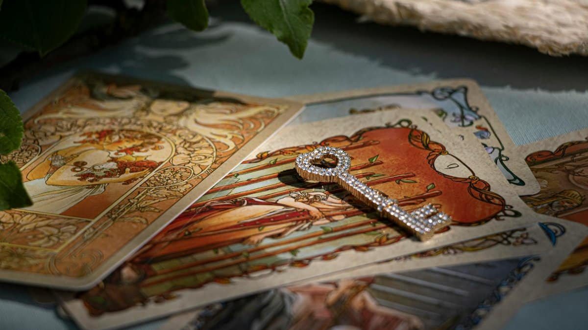 Artistic tarot cards with a sparkling crystal key, evoking mystery and fortune-telling.