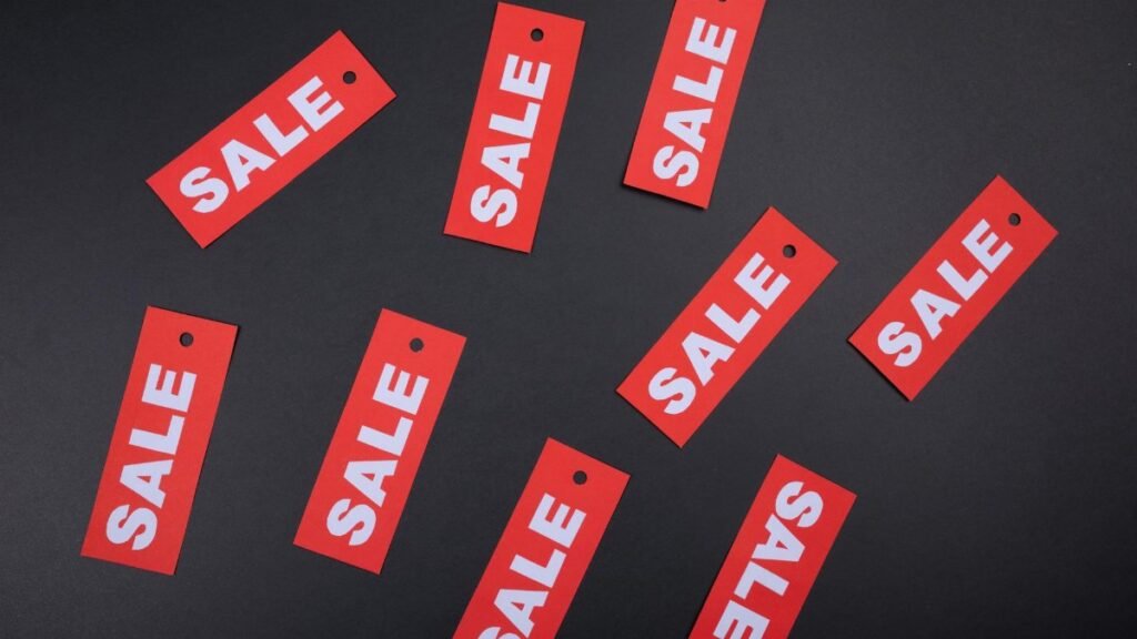 Red sale tags on a black background. Ideal for marketing and promotional use.