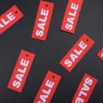 Red sale tags on a black background. Ideal for marketing and promotional use.