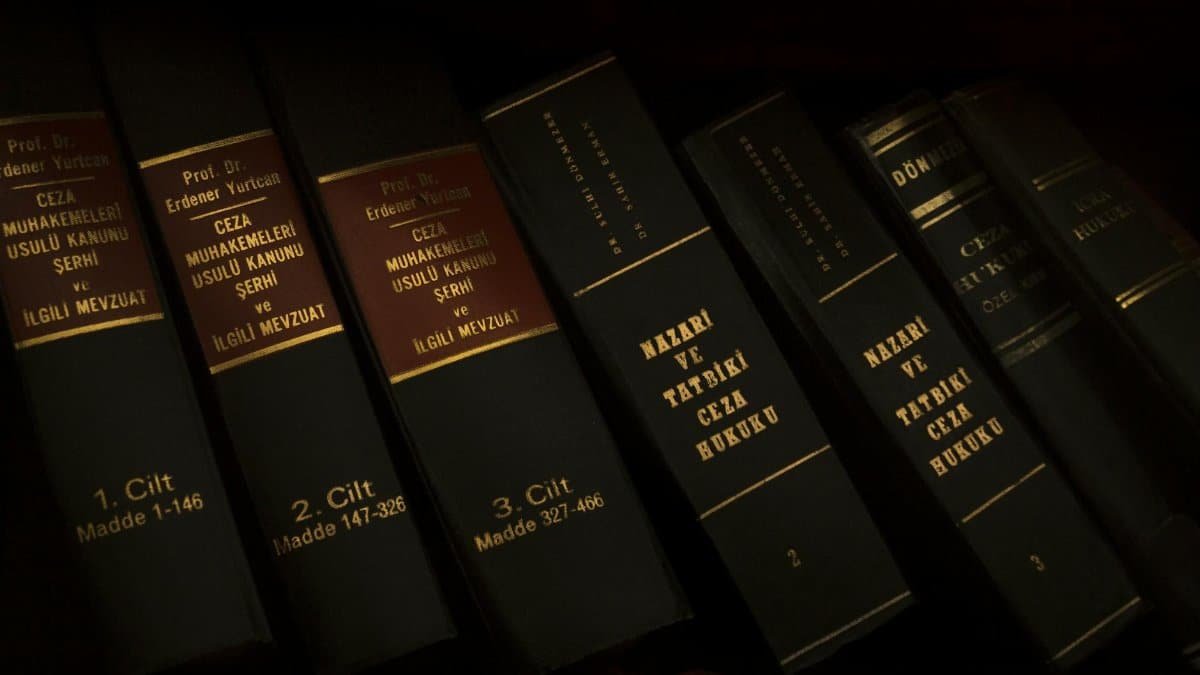 Stack of legal and literature books in a library showcasing various volumes.