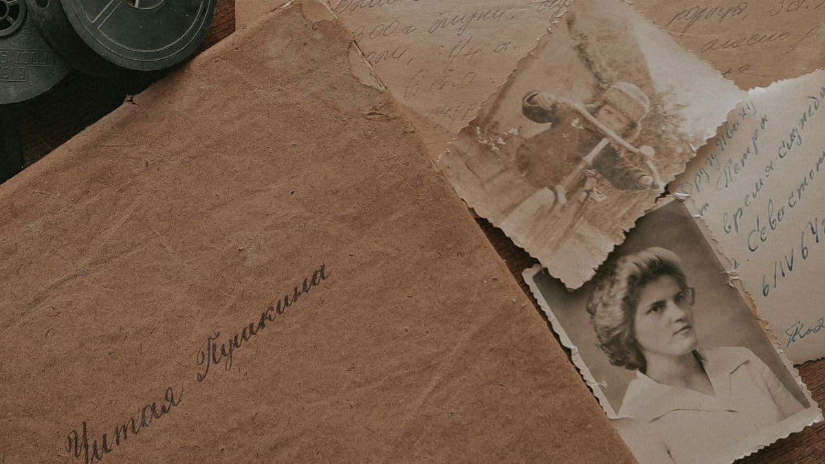 A nostalgic still life of vintage photographs, handwritten letters, and film reels, evoking a sense of the past.