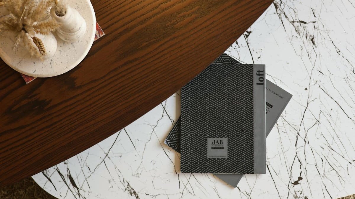 Stylish overhead shot of a minimalist coffee table with magazines, decor, and a modern vibe.