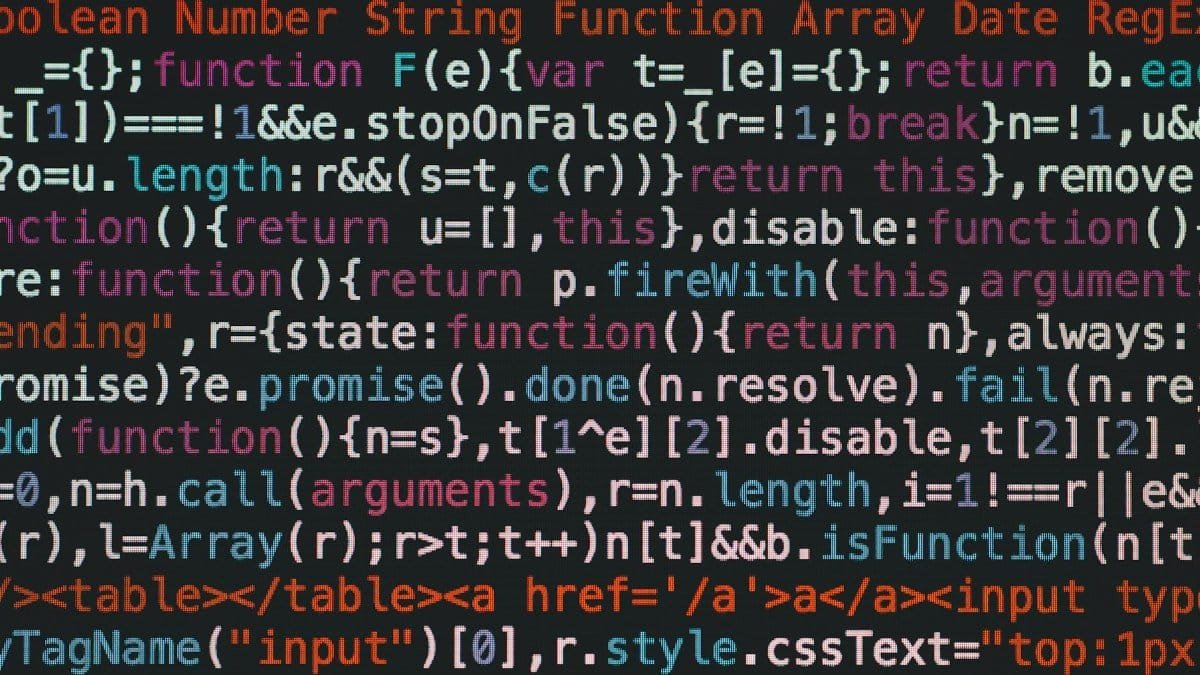 Close-up of colorful coding text on a dark computer screen, representing software development.
