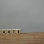 Scrabble tiles spelling 'reports' on a wooden desk, ideal for office or business themes.