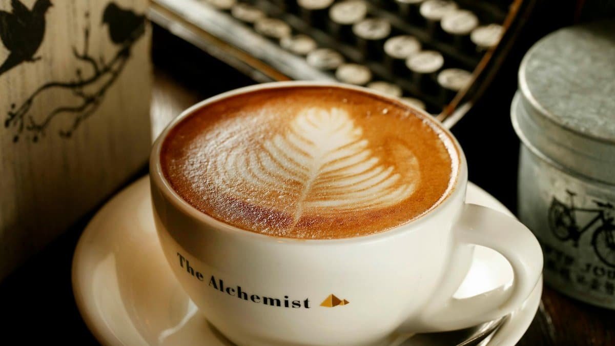 Close-up of a beautifully crafted latte art in a cafe setting, perfect for cozy atmosphere themes.