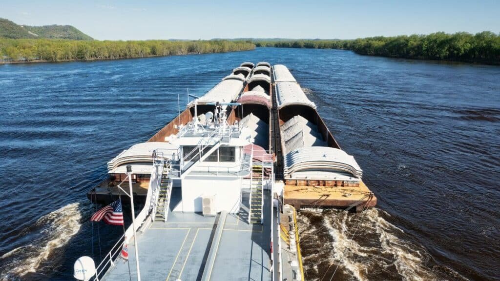 Cargo barge transporting goods on the Mississippi River near Wabasha, Minnesota.