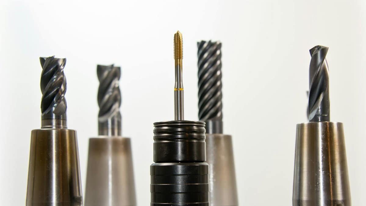A close-up view of metal drill bits arranged vertically, showcasing industrial tools.