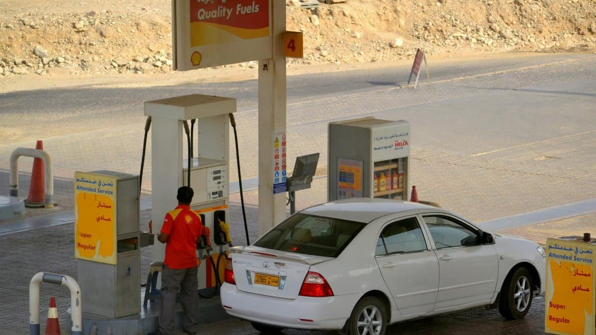 Attendant fueling a car at a Shell gas station in Muscat, Oman.