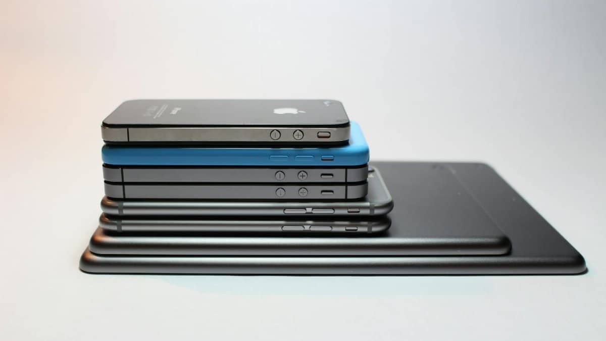 Stacked modern smartphones and tablets showcasing sleek design. Perfect tech background.