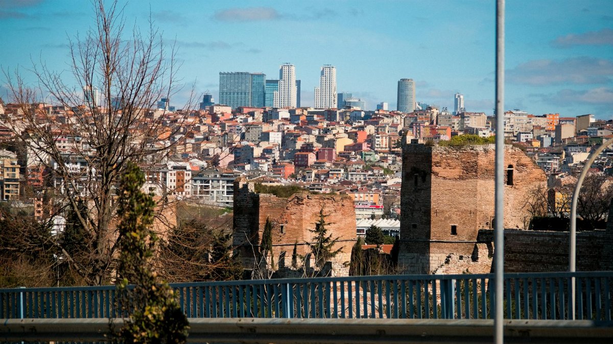 A view of Istanbul's historic walls juxtaposed against modern skyscrapers showcasing the city's architectural blend.