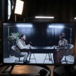 A podcast recording session in a studio with hosts in conversation, captured on screen.