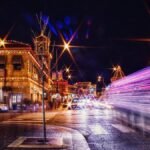 Long exposure captures the lively night scene of Kansas City with colorful lights and bustling streets.
