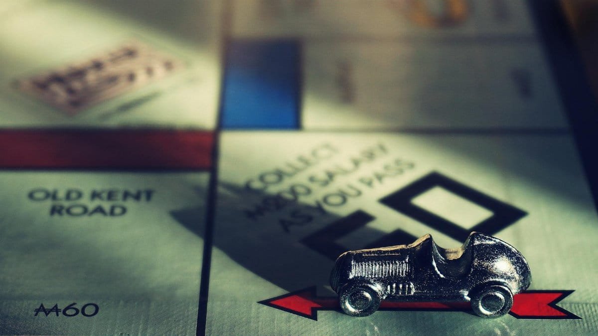 Detailed close-up of Monopoly board featuring the classic car token. Perfect for board game enthusiasts.