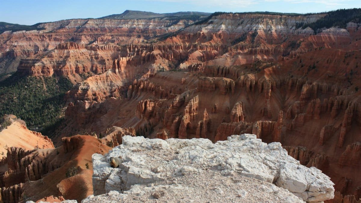 Explore the stunning landscape of Cedar Breaks National Monument, Utah, showcasing vibrant sandstone formations and rugged cliffs.