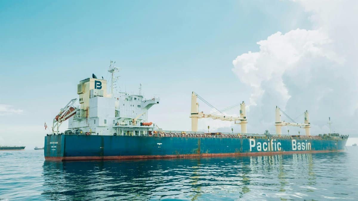 Cargo ship Pacific Basin navigating calm waters under a cloudy sky.