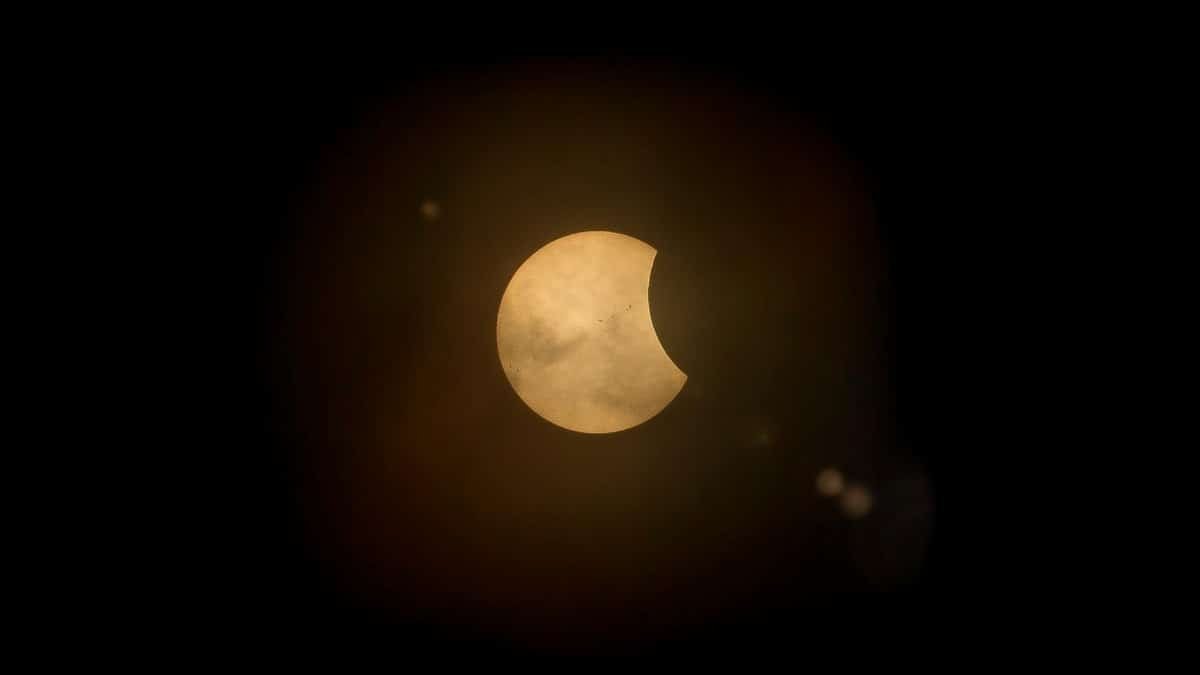 Captured partial solar eclipse set against a deep dark sky, perfect for astronomy enthusiasts.