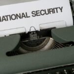 Close-up of a vintage typewriter with a paper marked 'National Security', symbolizing confidentiality.