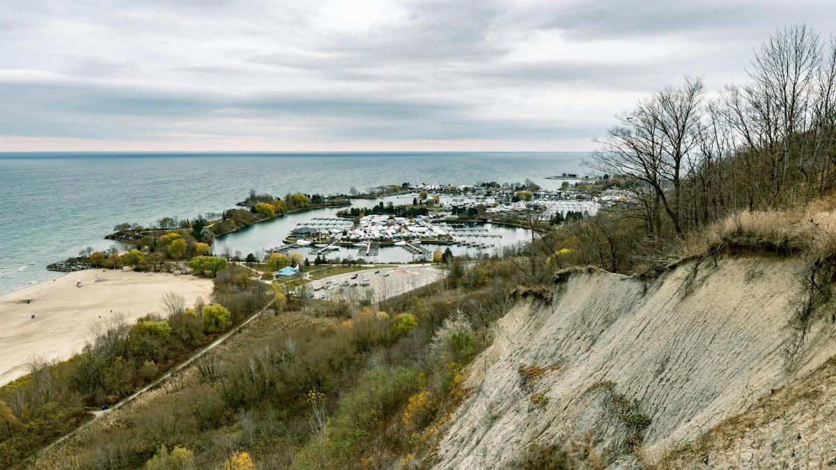 A scenic view of Lake Ontario's beach and marina from a high vantage point.