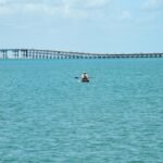 A peaceful day canoeing on the sea with a bridge in the background at South Padre Island, Texas.