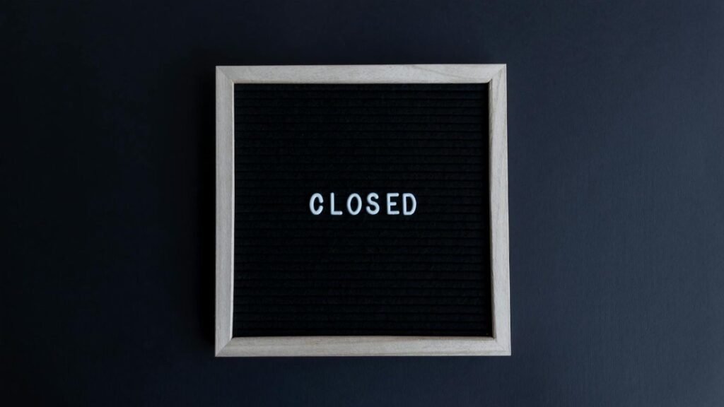 Black letter board with the word 'CLOSED' in white on a dark background.
